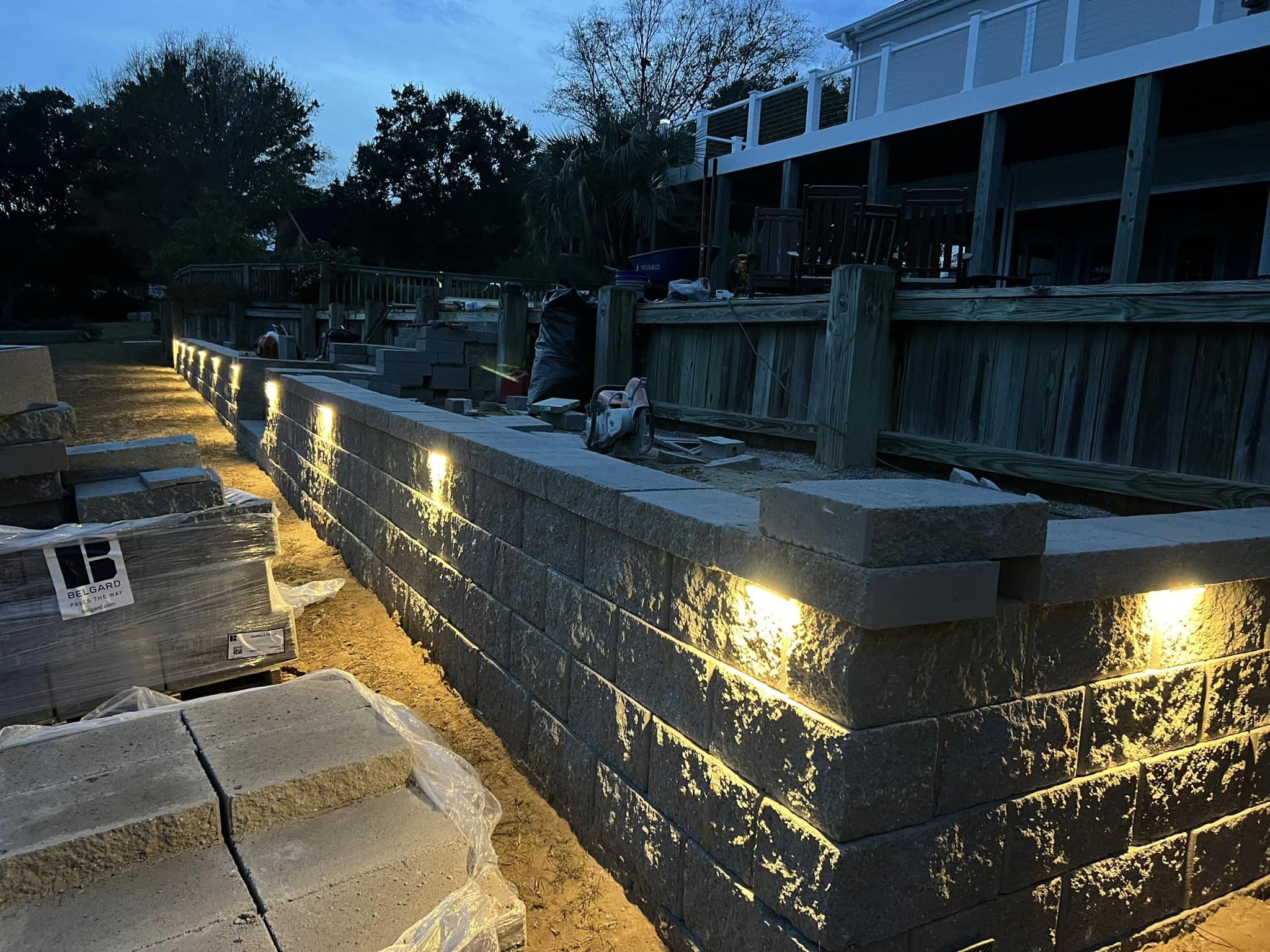 Large retaining wall installation with lights at nighttime