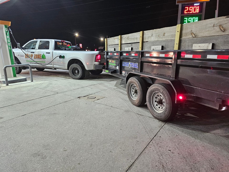 Construction and Demolition Service Dode Ram Truck Hauling a Debris Removal Trailer