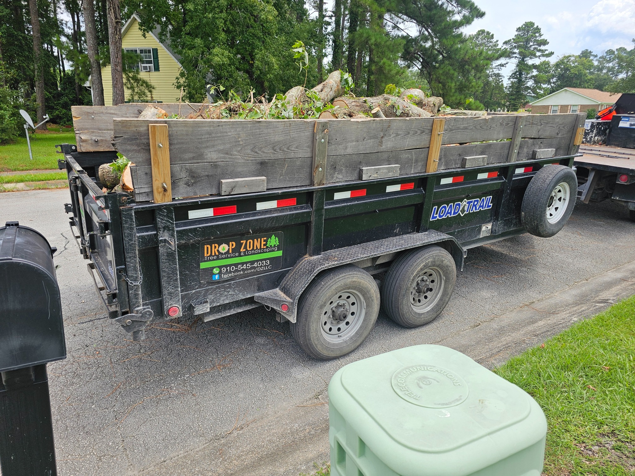 Yard Waste and vegetation removal yards waste in a large dump truck taken form a site with vast amounts of vegetation