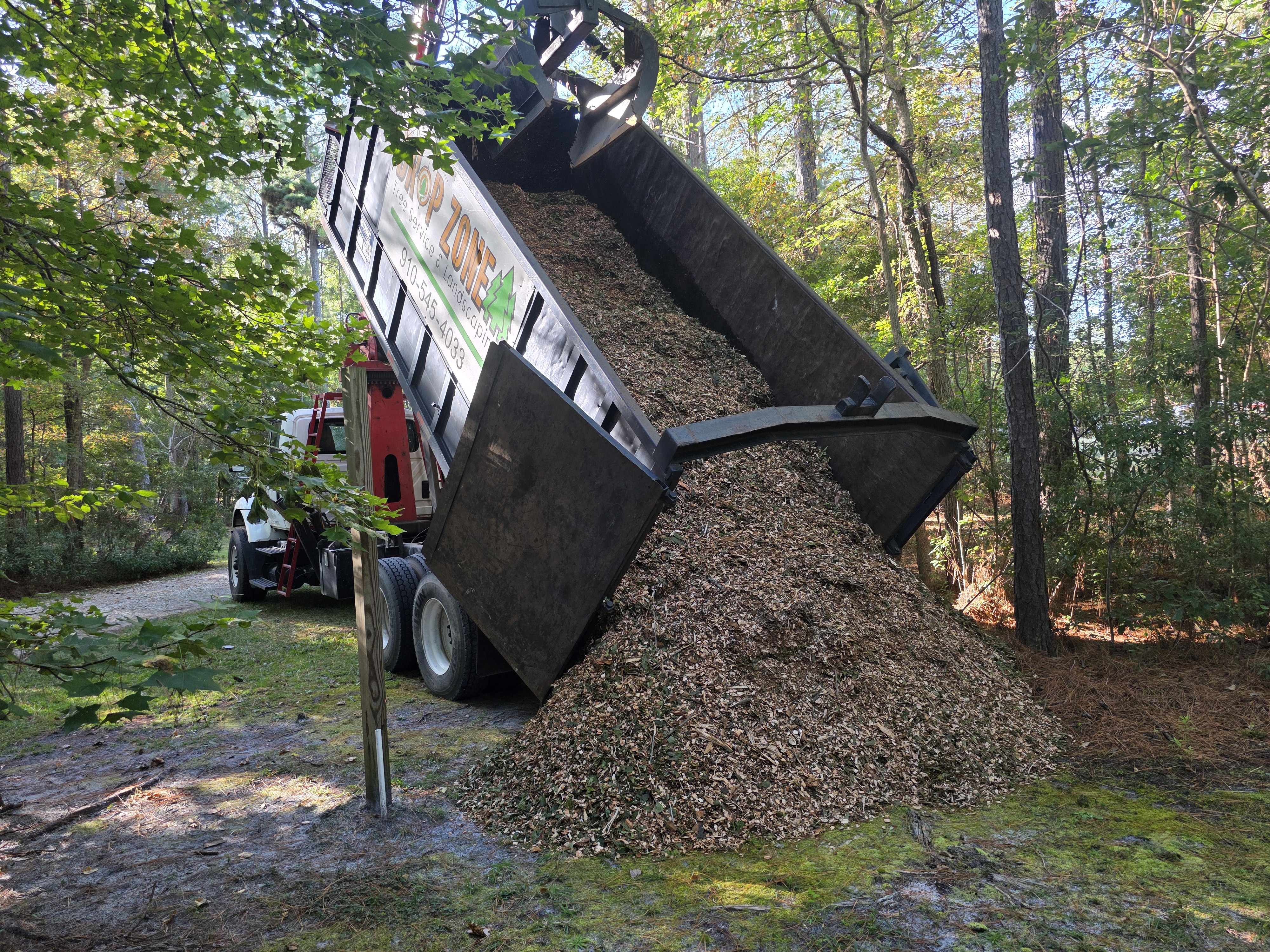 Grapple Truck Dumping Excess Wood Chips