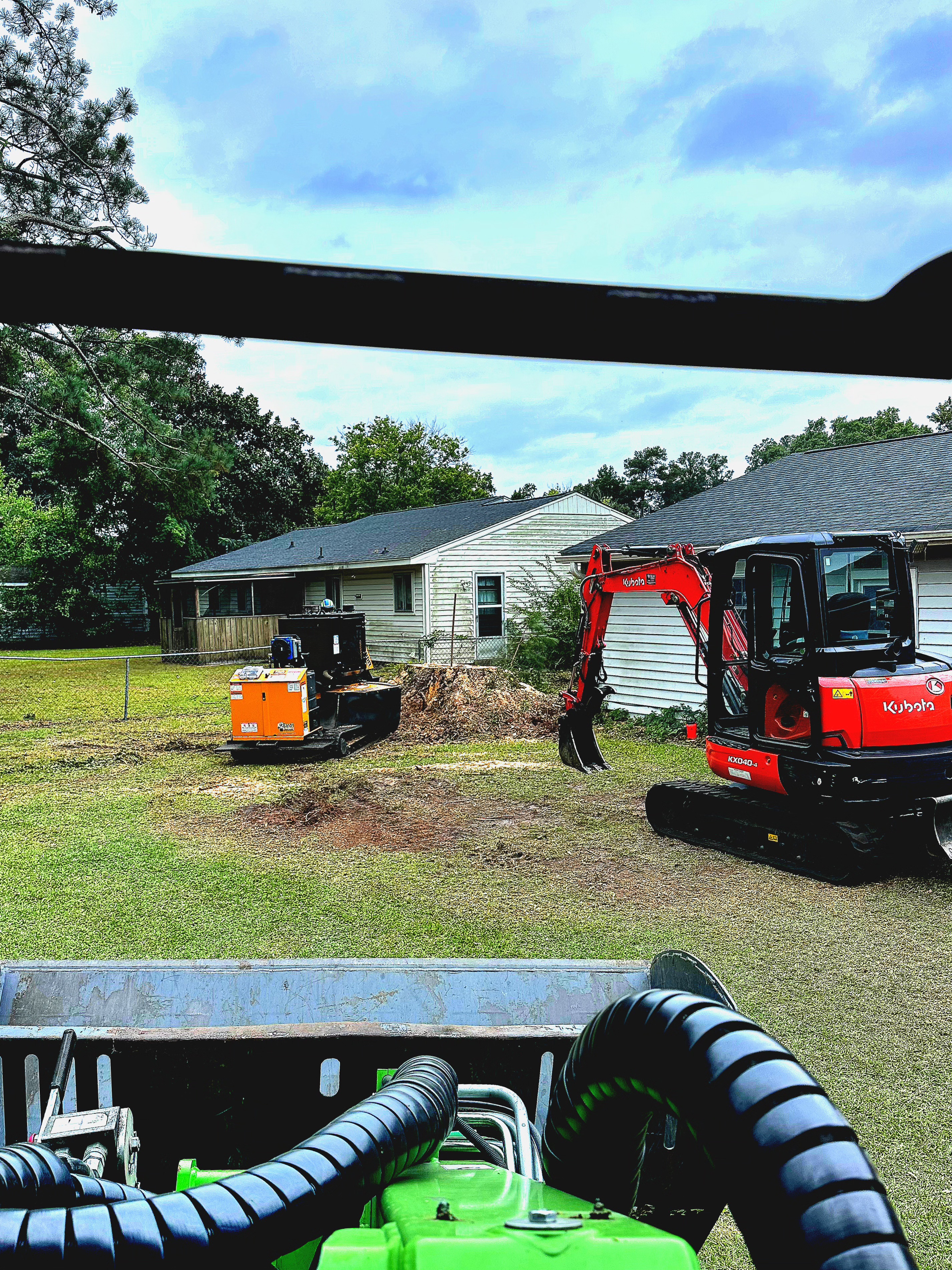 Machines removing brush piles for backyard access