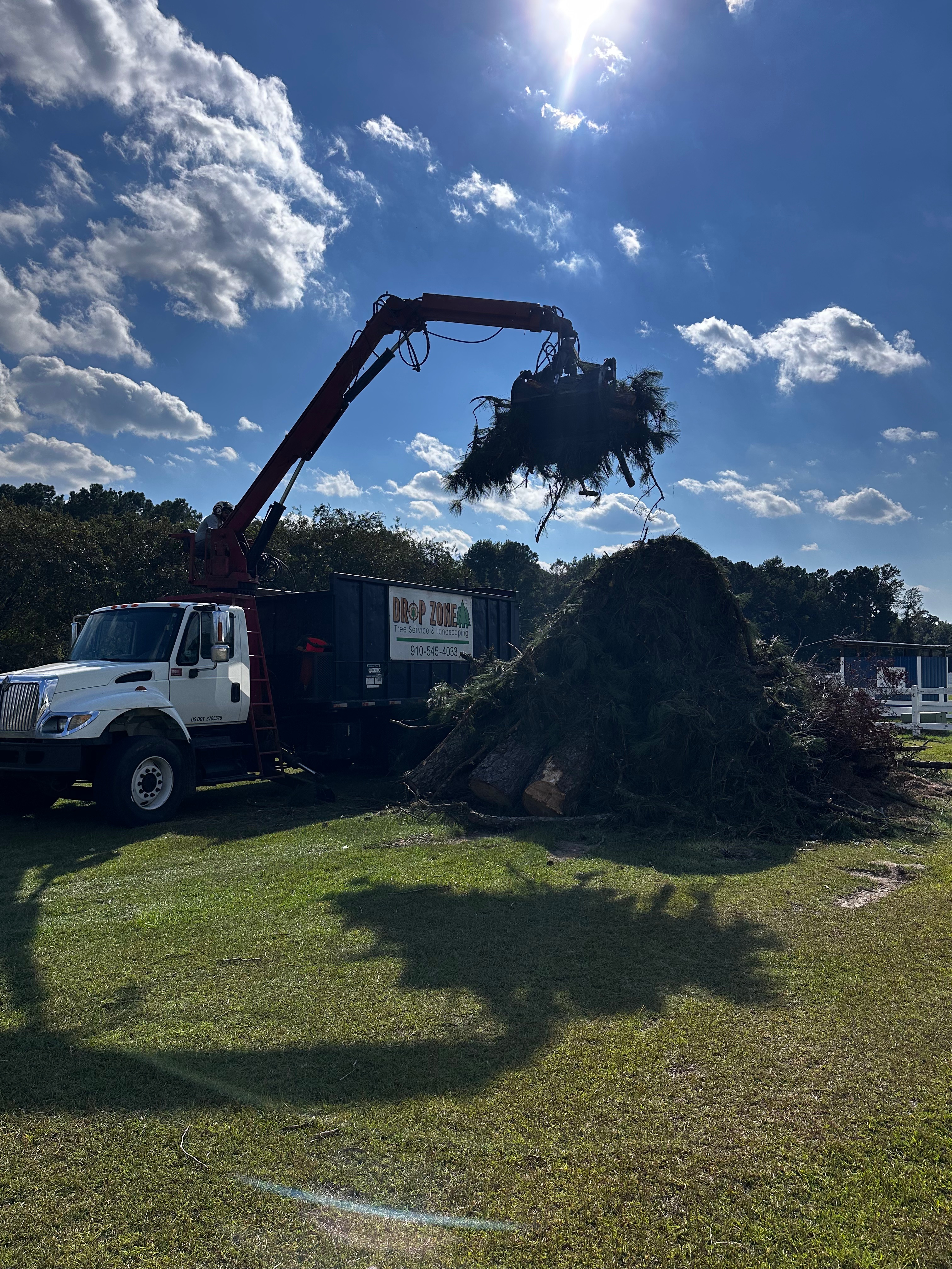 Grapple Truck Moving Debris with Grapple Arm